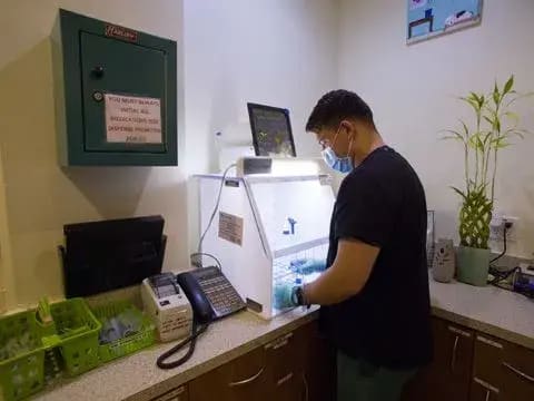 A team member runs samples at the in-house laboratory station
